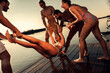 © Zoran Zeremski - Friends having fun enjoying a summer day swimming and jumping at the lake.