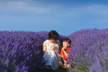 Canvas Print - mother and son having fun in lavender