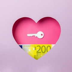 The key to the door and the two hundred euro banknote are in a pink heart on a purple background. Minimal concept of money, love and real estate.