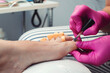 © volurol - Woman having pedicure at salon. Pedicure and foot care treatment. Female relaxing at salon, caring about nails.