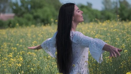 Wall Mural - Pretty young woman in the rapeseed field