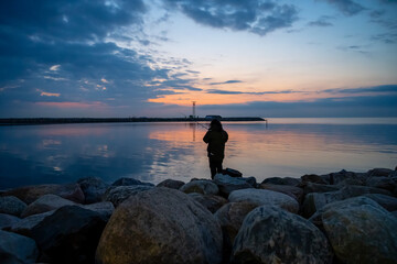 A woman fishing in a beautiful sunset. Picture from The Island, Malmo, Sweden