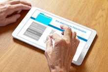 Hands Of An Old Woman Touching The Screen Of A Tablet Computer, Translation Of German Text: Your Personal Patient Record.
