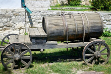 Vintage Wooden Water Barrel On Wheels In The Backyard. Old Traditions.