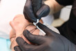 © Roman - a tattoo artist holds the client's eyebrow with her hand, thereby stretching the skin and performing permanent makeup with a machine