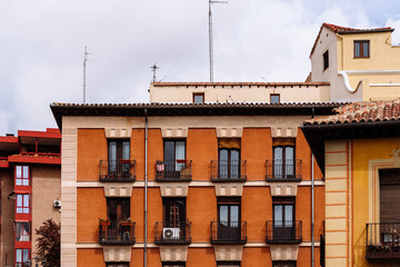 Wall Mural - Old Traditional Residential Buildings in Central Madrid. Colorful Facades Against Cloudy Sky