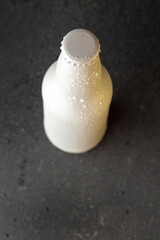 Poster - Top view of a white soda/beer bottle with water drops