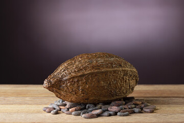 Sticker - Cocoa pods with cocoa beans on a table with a black backdrop