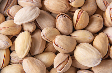 Pistachios texture and backdrop.Tasty nuts as background texture. Healthy and vegan food. Top view, macro and flat lay