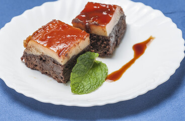 Two pieces of delicious chocolate flan cake on a white plate