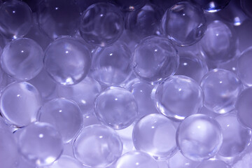 Macro abstract texture background of super absorbent polymer water gel beads with the texture of soft clear wet marbles