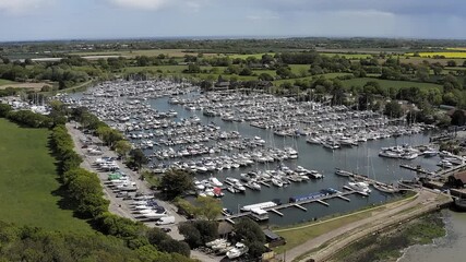 Wall Mural - Aerial approaching Chichester Marina full of yachts and boats a popular sailing destination in the beautiful countryside of West Sussex in Southern England.