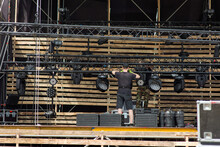 Workers Install Floodlights On A Mobile Stage On A Removable Suspended Truss
