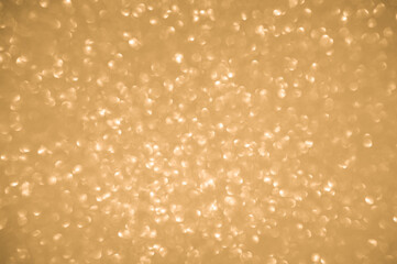 Gold glitters background. shimmering blur spot lights Bokeh Shiny gold light background.