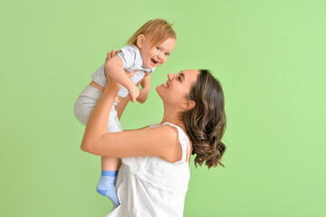 Canvas Print - Happy woman and her little daughter on color background