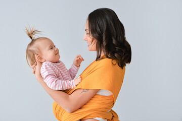 Canvas Print - Happy woman and her little daughter on light background