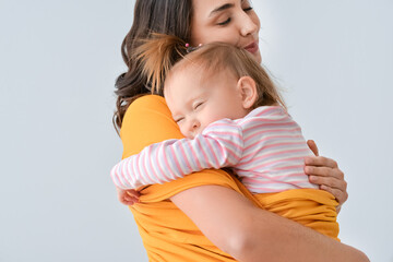 Canvas Print - Happy woman and her little daughter on light background