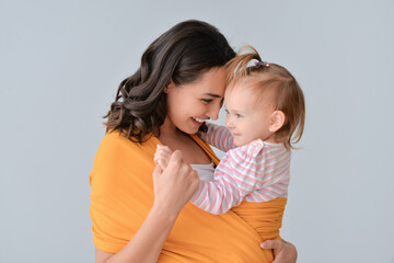 Canvas Print - Happy woman and her little daughter on light background