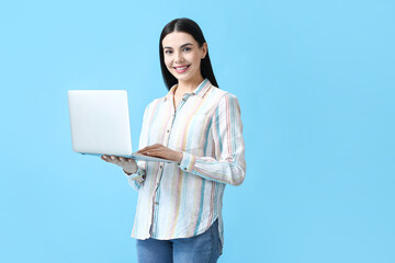 Beautiful young woman with laptop on color background