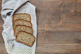 Fototapeta Kuchnia - Slices of bread on a wooden table