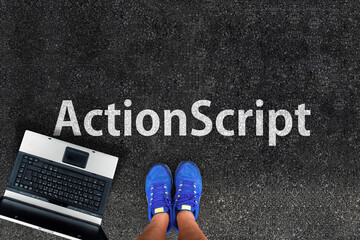 actionscript programming language. legs in sneakers standing next to laptop and word actionscript