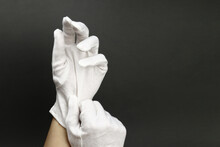 Woman puts on White cotton gloves to moisturize the skin