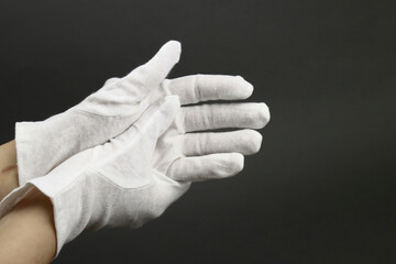 Wall Mural - Woman puts on White cotton gloves to moisturize the skin