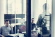 © kasto - Business team leader delivering presentation in office.