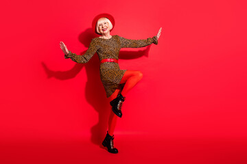 Wall Mural - Full body photo of cheerful aged woman happy positive smile enjoy music dance isolated over red color background