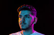 © master1305 - Young man's portrait on black studio background in neon light. Concept of human emotions, facial expression, youth, sales, ad.
