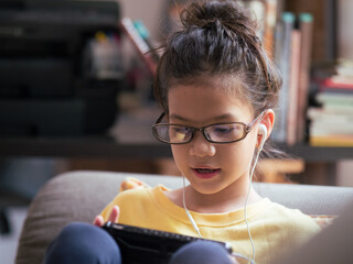 School kid wearing eyeglasses using internet of things .Nerd culture.	