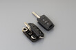Broken Or Damaged Car Key Fob And New Remote Vehicle Key On Grey Background. Repair Of Broken Or Damaged Remote Key Fob Of Any Vehicle Car Service.