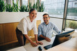 © Jacob Lund - Manager with colleague smiling at camera