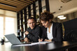 © bnenin - Businesswoman taking notes while businessman talks, portrait.