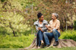 © bnenin - Adult man and woman, sitting next to each other, drinking coffee.