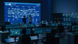 © Gorodenkoff - Project Manager and Computer Science Engineer Talking while Using Big Screen Display Showing Infrastructure Infographics and Data.Telecommunications Company System Control and Monitoring Room