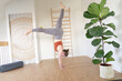 © MIRA NOVA ROSE - Young woman practicing yoga in her studio