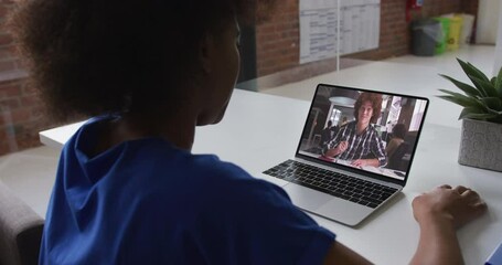 Canvas Print - African american female teacher talking on video call with male college student on laptop at school