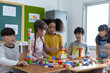 © JR-50 - Diversity of school students playing wooden blocks in classroom
