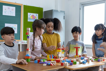 diversity of school students playing wooden blocks in classroom