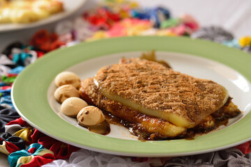 Typical Brazilian dessert, known as Cartola or top hat dessert, made with fried plantains, cheese, sugar and powdered chocolate.