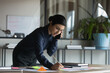 © fizkes - Focused young Indian female employee talk speak on smartphone prepare business paperwork project in office. Serious ethnic businesswoman have cellphone call work on financial startup project.