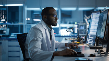Modern Electronics Development Facility: Male Engineer Works on Computer with CAD Programming Software. Scientists Design of Industrial PCB, New Generation Silicon Microchips, Semiconductors