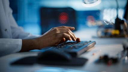 Wall Mural - Modern Electronics Research, Development Facility: Engineer Working on Computer, Typing with His Hands on a Keyboard. Scientist Design PCB, Silicon Microchips, Semiconductors. Close-up Focus on Hands 