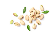 Flat Lay Of Pistachio Nuts With Leaves On A White Background.