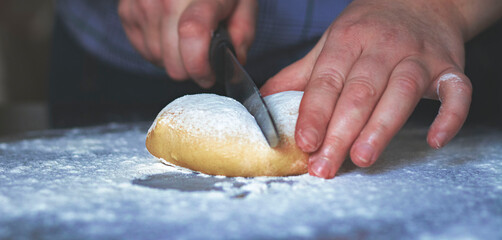 hands cutting dough