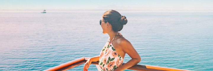 Cruise ship travel vacation woman looking at ocean from balcony of yacht deck. Luxury exotic tropical destination summer lifestyle.