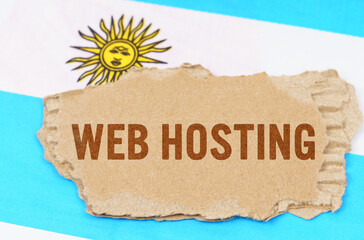 Against the background of the flag of Argentina lies cardboard with the inscription - Web Hosting