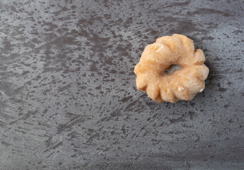 Wall Mural - Cruller shaped donut on a gray background