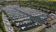 Aerial Footage Of Yachts And Boats On Pontoons At Chichester Marina A Popular Sailing Destination In The Beautiful Countryside Of West Sussex In Southern England.